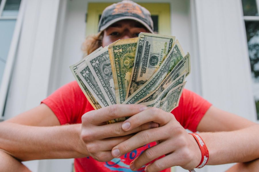 Young man sitting and counting cash