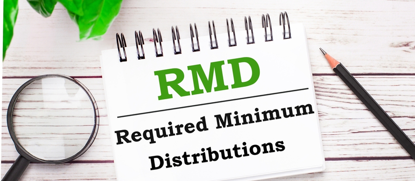 RMD, Required Minimum Distributions written on a note pad