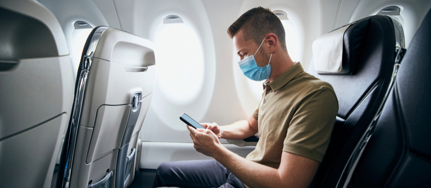 Man sitting on plane with face mask