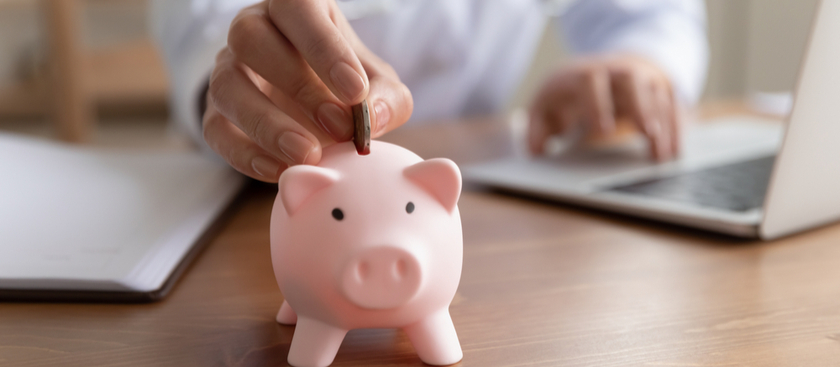 Putting a coin in piggy bank