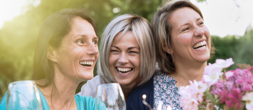 Three ladies smiling and laughing together