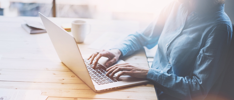 Person sitting and typing at desk in Jacksonville