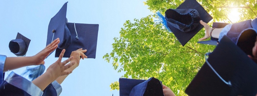 Graduates throwing up their caps