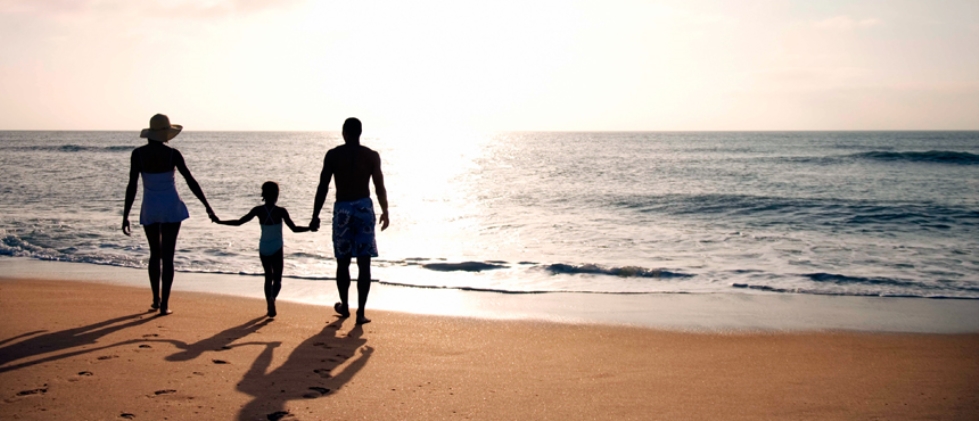 Family holding hands on the beach