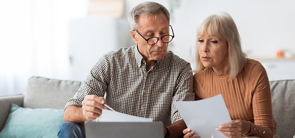 Senior citizens overlooking paper work together