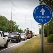 Evacuation Route sign with traffic lined up on the road