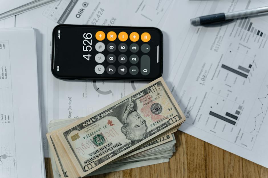 Money sitting on table with calculator and tax papers